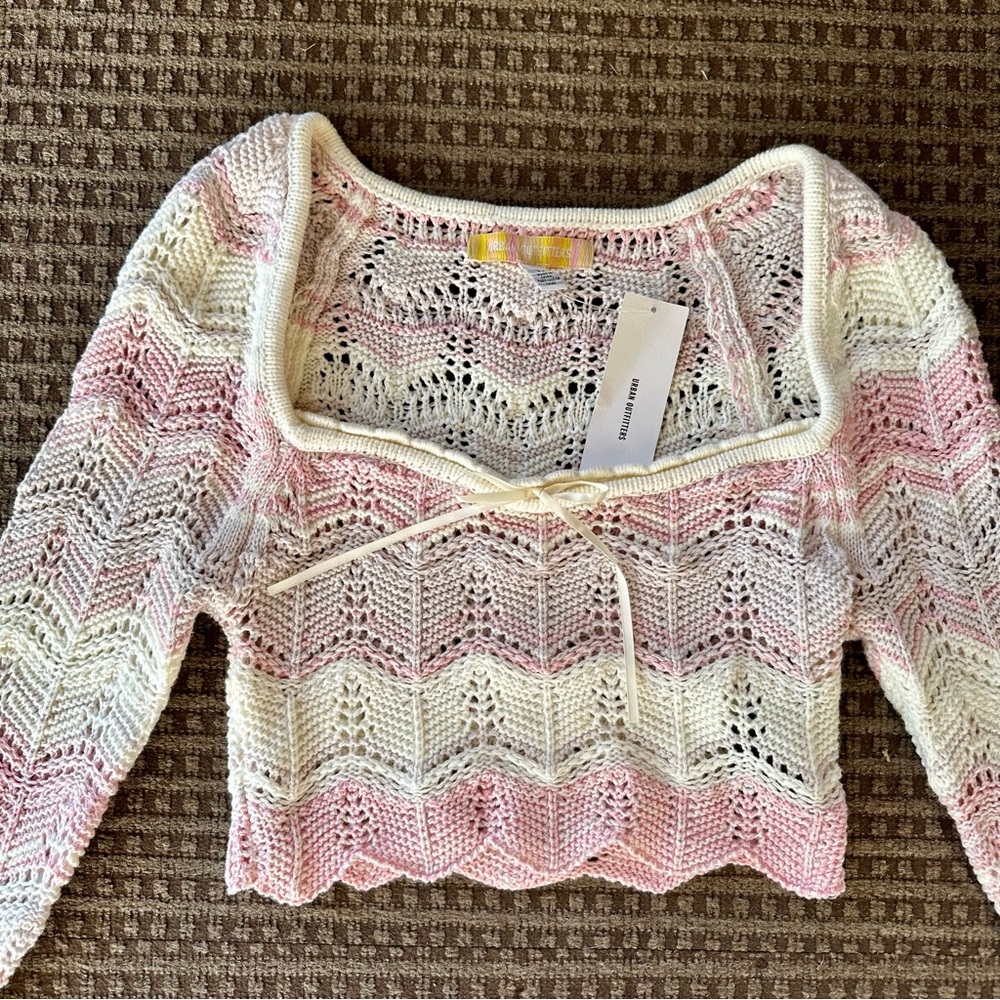 Crochet pink, purple, and white cropped sweater with bow and scalloped hem